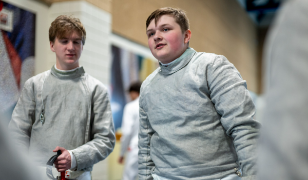 FIRE FENCING. Junior Howard Huelster talks to his teammates before he competes. Photo from SPA SmugMug.