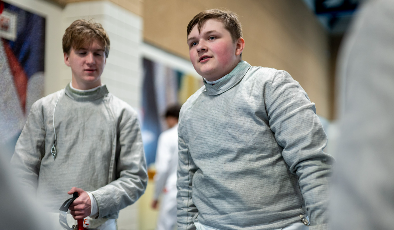 FIRE FENCING. Junior Howard Huelster talks to his teammates before he competes. Photo from SPA SmugMug.