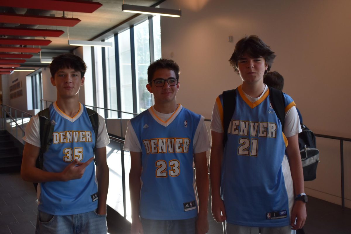 THREE OF A KIND. Sophomores Whitsun piper, Eli Kardasis-Sturtz, and Bayne Talbot (left to right) show up to school wearing the exact same thing: Denver Nuggets jerseys, blue jeans, with white 
t-shirts underneath. When asked how they all have the same jersey, Kardasis replied with "we got them on eBay for $15". 