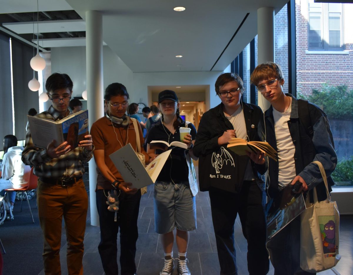 TRENDS. "Performative men" have recently become a new epidemic on Tiktok, with men wearing vintage headphones, drinking matcha, and reading a philosophical book. So to turn trend that into a rhyme without reason outfit, seniors Roman Farley, Ethan He, Ella England, Howard Huelster, and Evan Morris (left to right) decided to dress as performative and informative. 