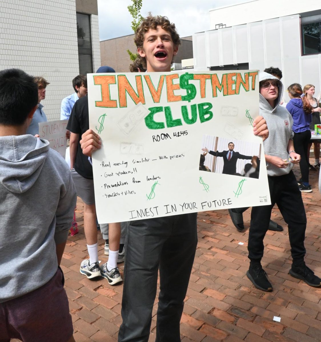 INVEST WITH US. Senior Patrick Wall, leader of the Investment Club, yells at students to join his stock club.