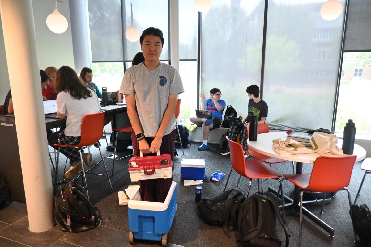 COOL BACKPACK. Senior Ethan He brought a cooler and a fishing tackle box for anything but a backpack day. "The cooler was the only thing in my house that could hold my things," he said.