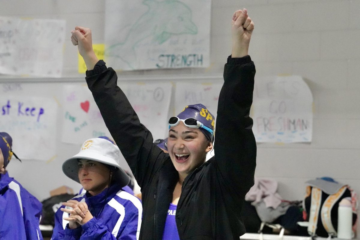 CHEER. Sparks swimmer cheers on her teammate at the end of the pool.