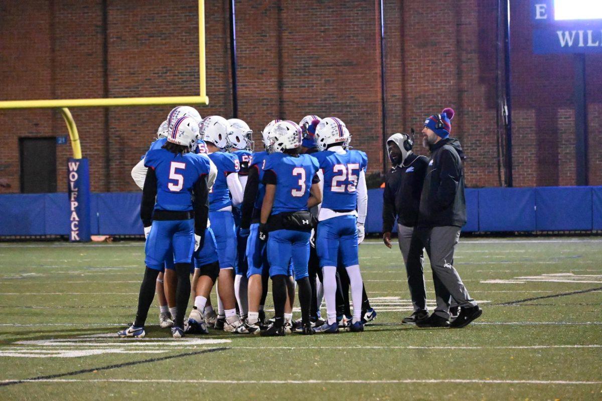 TIMEOUT. The coaches huddle with the player on the field to discuss strategy.