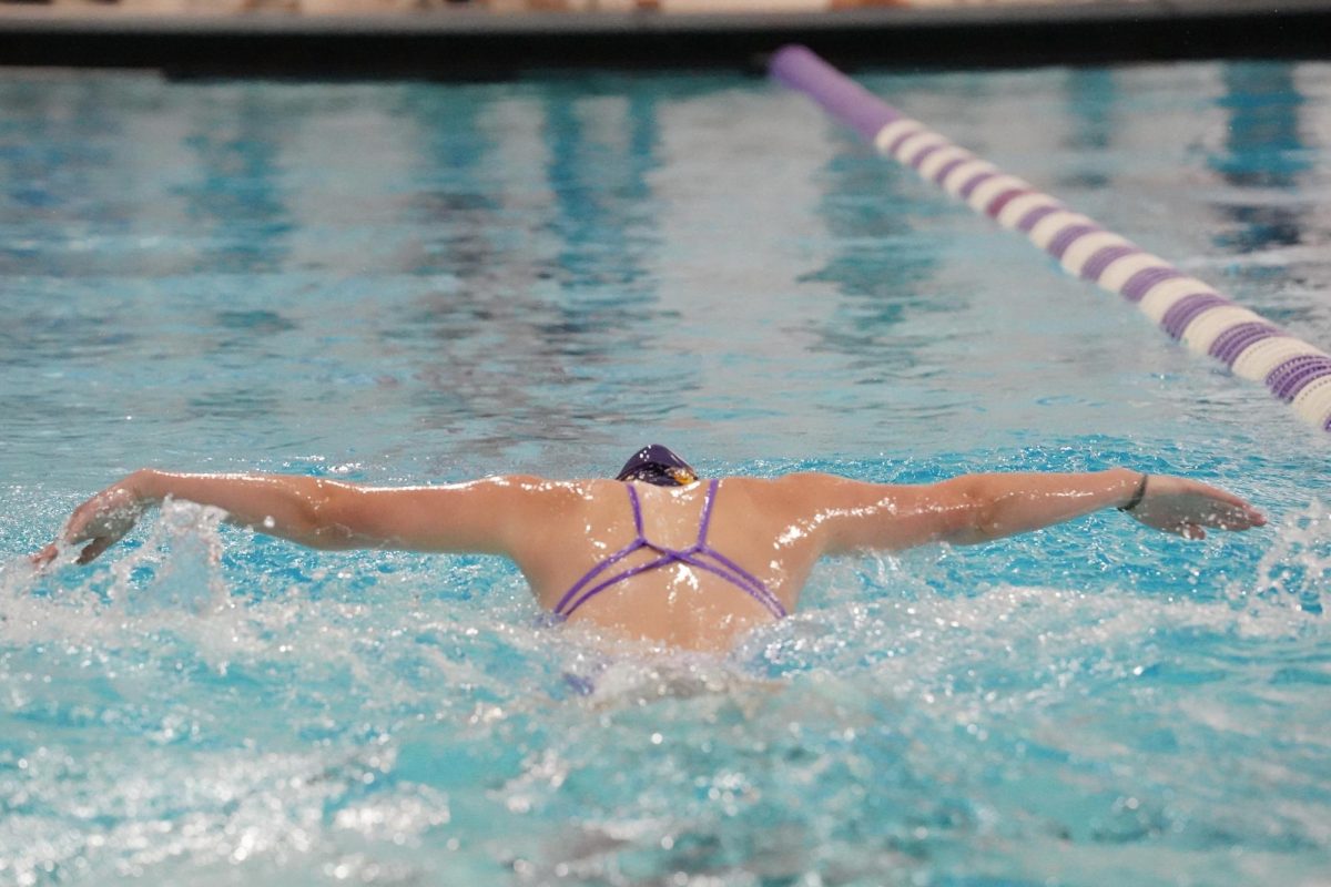 HEAD DOWN. Senior Lilly Currie swims the 100 yard butterfly.
