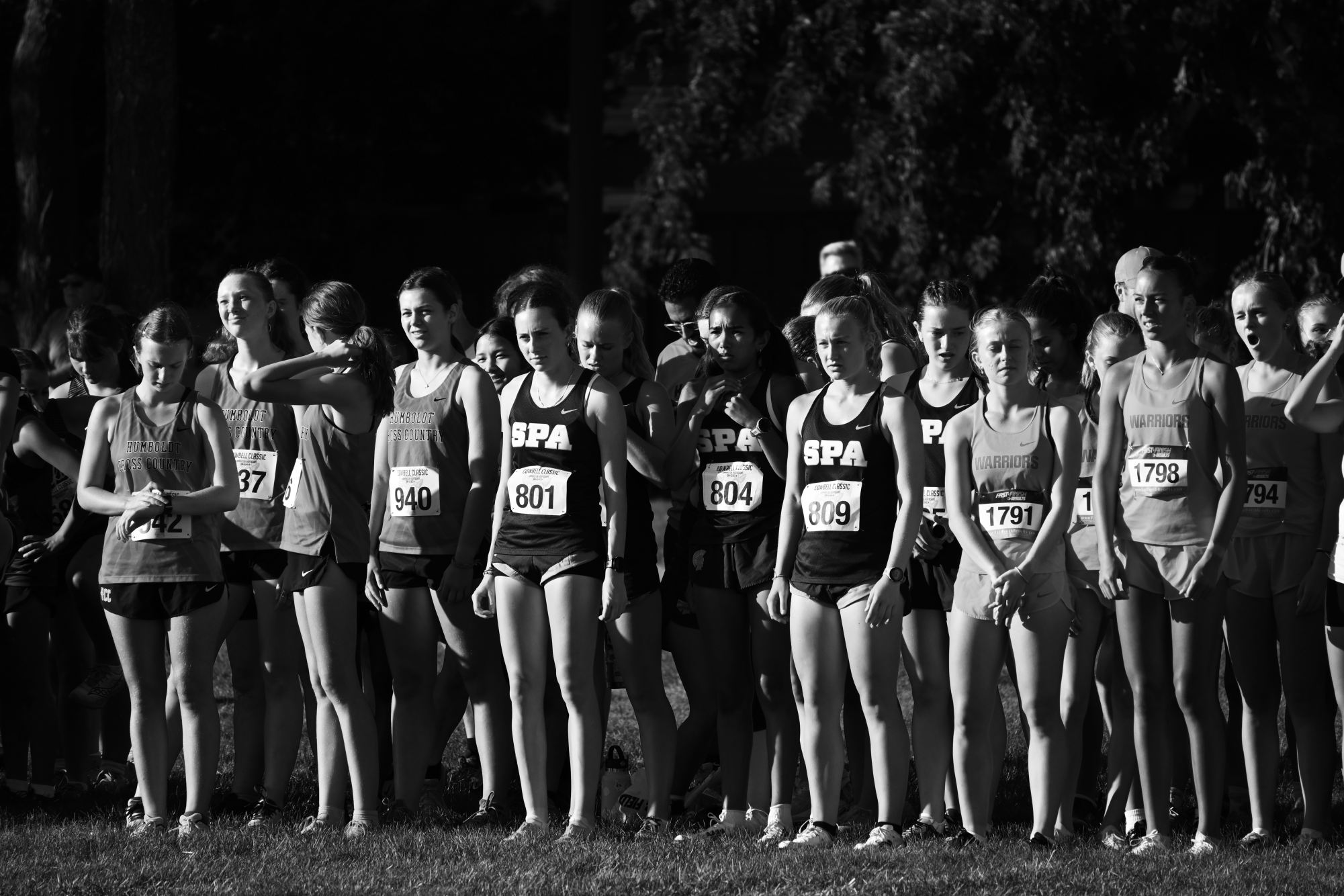 READY TO RACE. Cross country runner Paloma Good and the varsity girls cross country team wait at the starting line at a meet in Farmington Sept. 25.