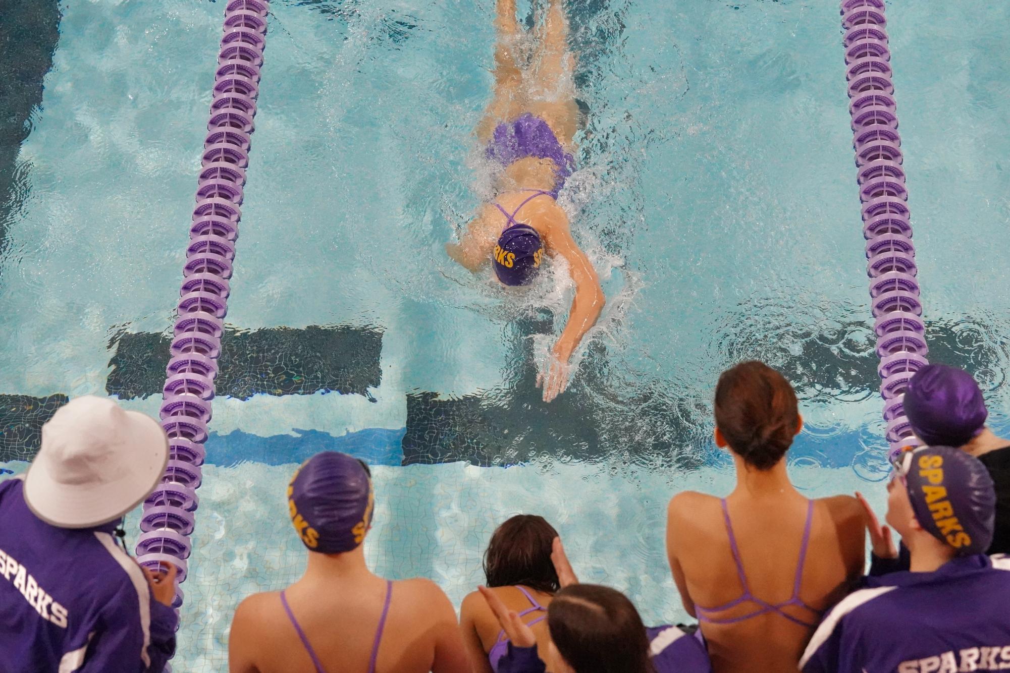 ON DECK. Swimmers cheer on their teamates on the pool deck