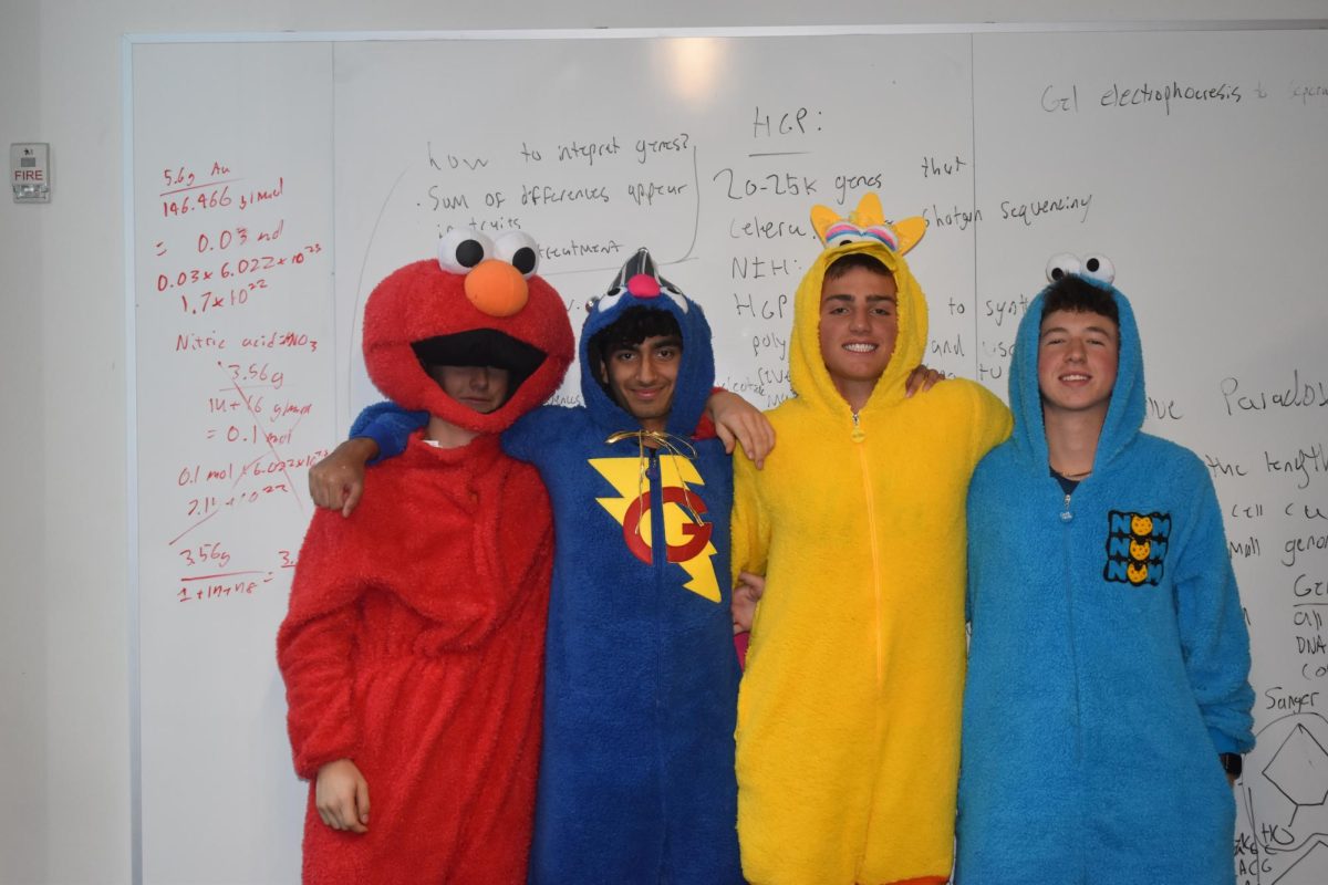 SESAME SQUAD. Juniors Gus Hembre, Zahir Hassan, Miles Vogenthaler, and Henry Fenlon (left to right) throw it back to their childhood, dressed in sesame street onesies. 