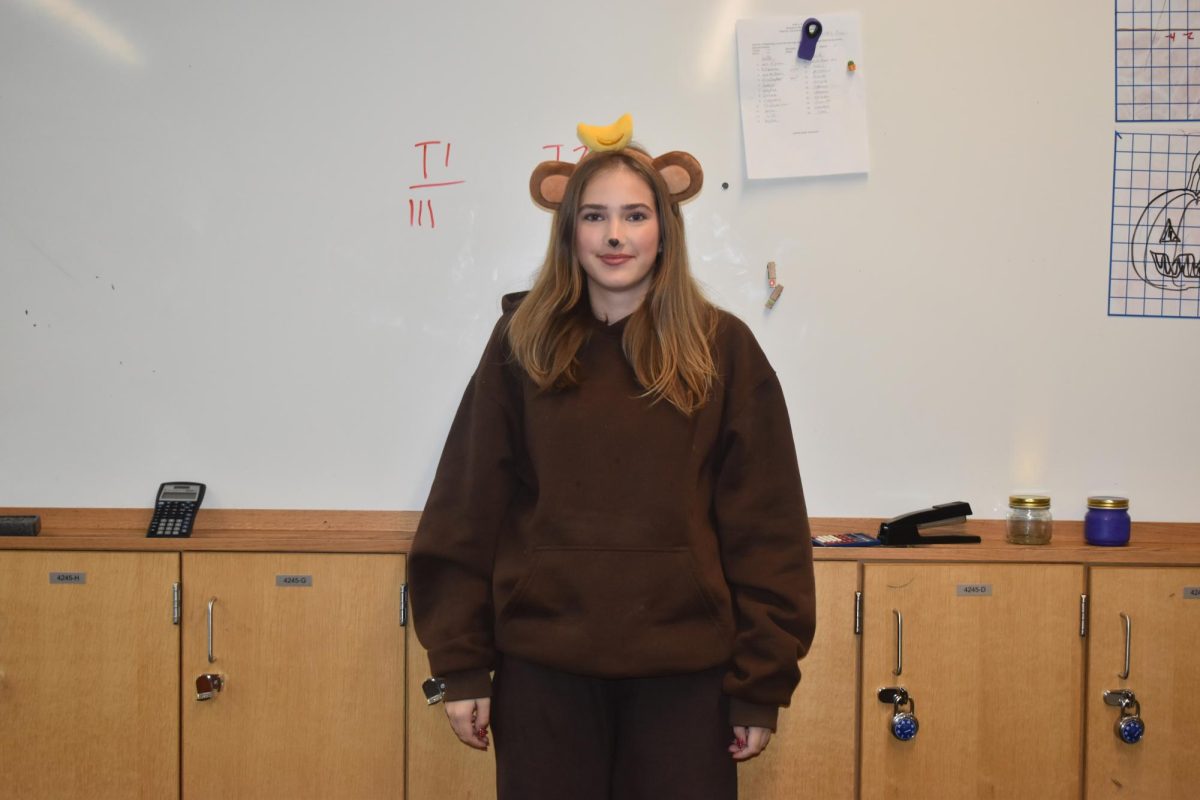 MONKEY BUISNESS. Dressed both comfy and cute, 9th grader Siri Holden brings Curious George out of the storybook and into the Halloween party.