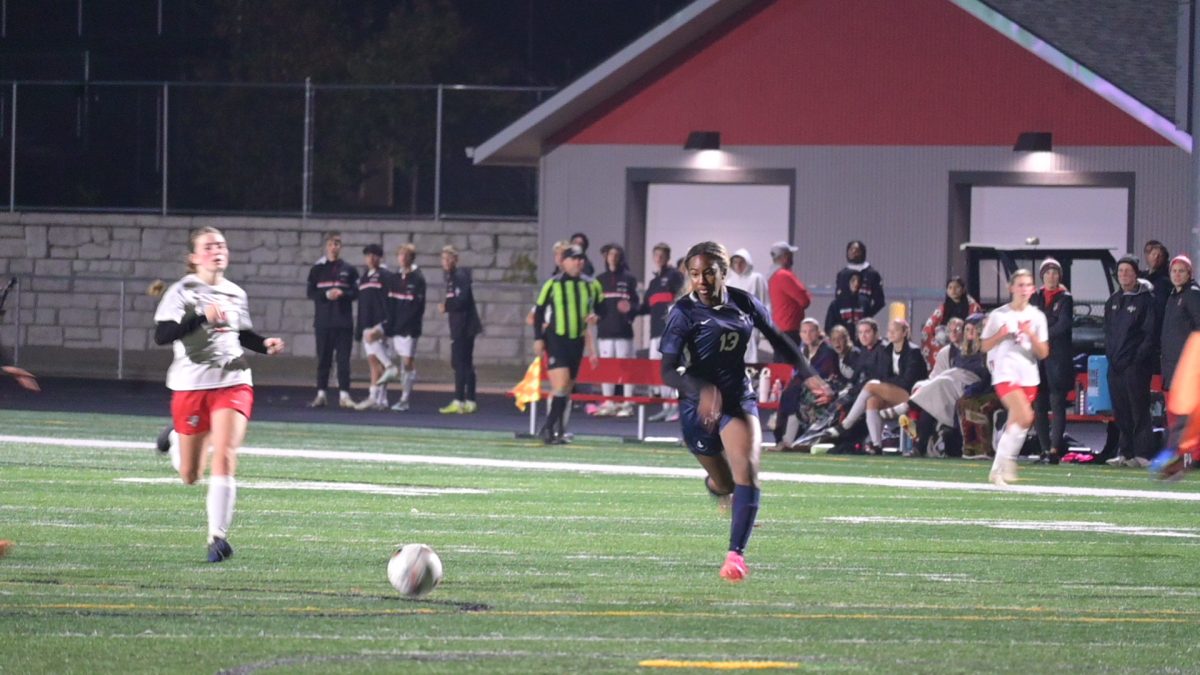 SPRINTS. Sophomore Sophia Obi races with the opponent to get to the ball.