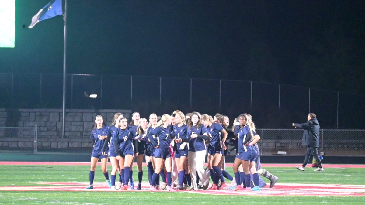 POSTGAME PRIDE. The team huddles up and celebrates after winning the game, earing the title of section champs.