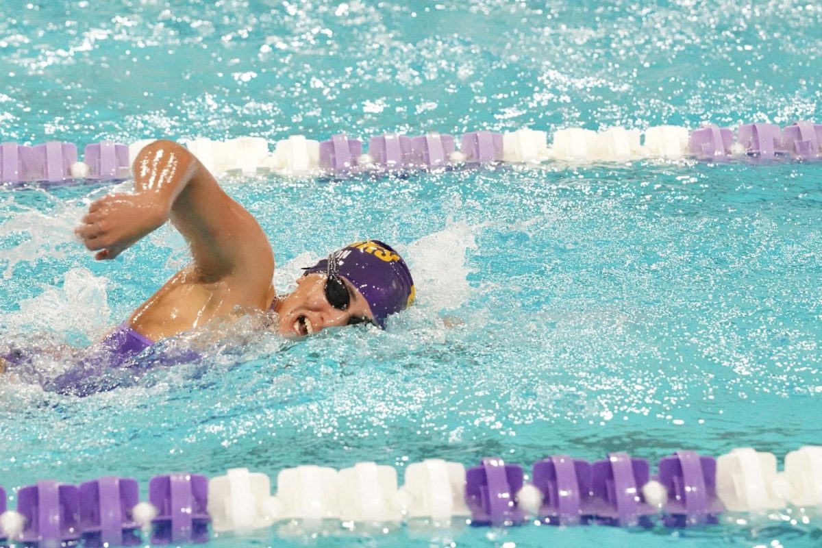 FORM. Senior Devi Nelson brings her arm over her head while swimming freestyle.