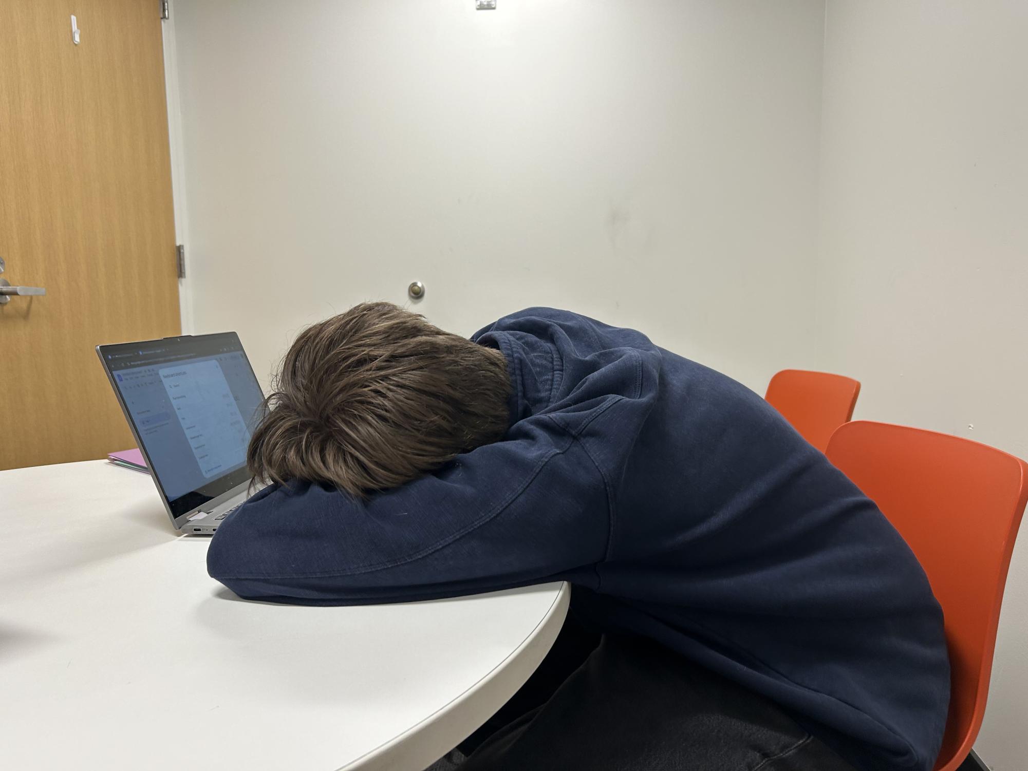 BURNT OUT A student lays on his computer in exhaustion, unable to write anything. Feeling unmotivated is a good reason to have a reset.