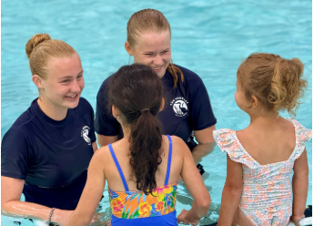 POOL PARTY. Sophomore Alyda and senior Maren Overgaard instruct swim lessons at the Rookery Aquatics Center. “It’s really fun to teach the kids and watch them get more confident in the water,” Alyda said. (Submitted by Alyda Overgaard)