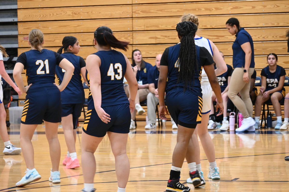 TOGETHER. Senior Zimo Xie and captain Nijah Johnson walk away after high-fiving each other. 