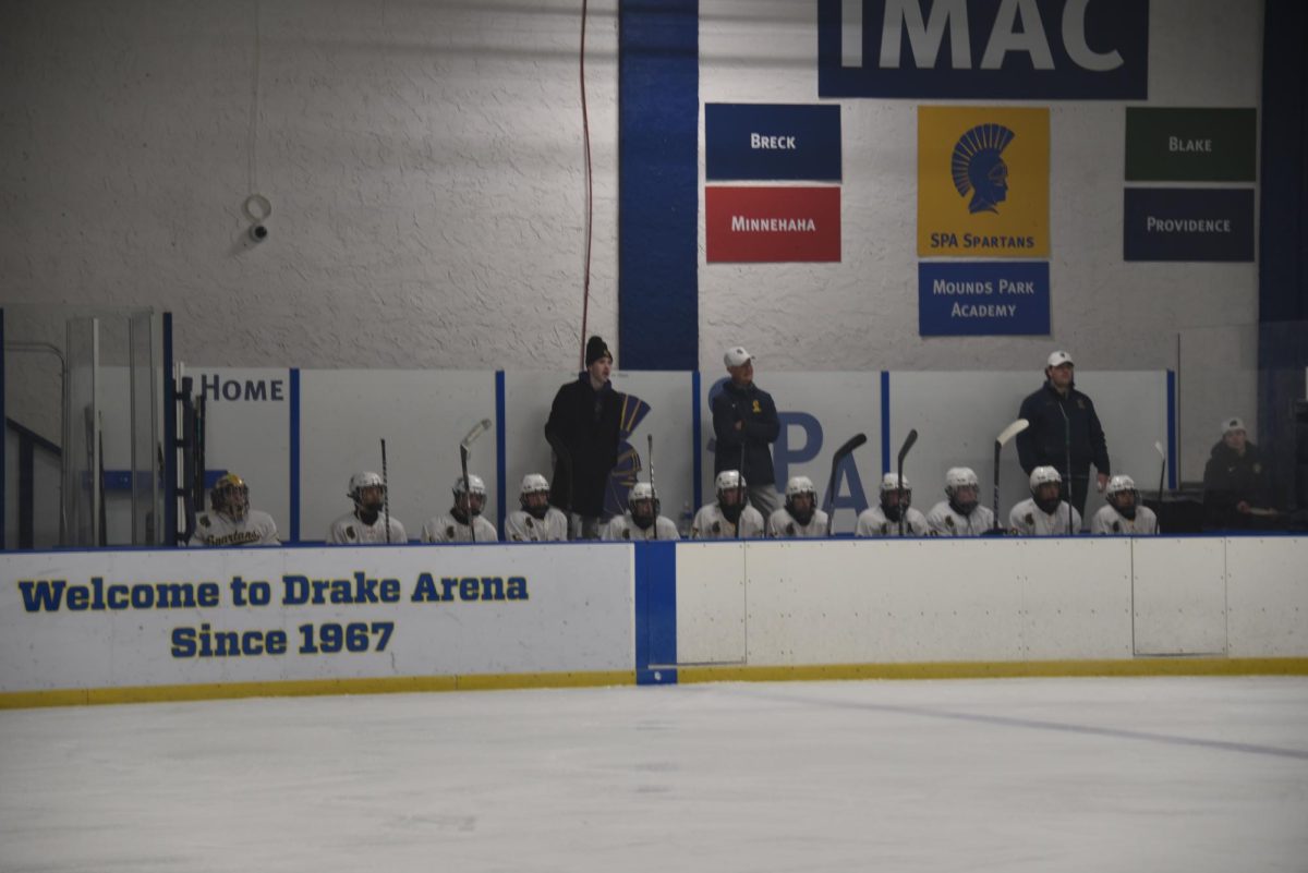 SUPER FOCUS. The bench watches the game during the first period, where they cheer on the players who are on the ice. 