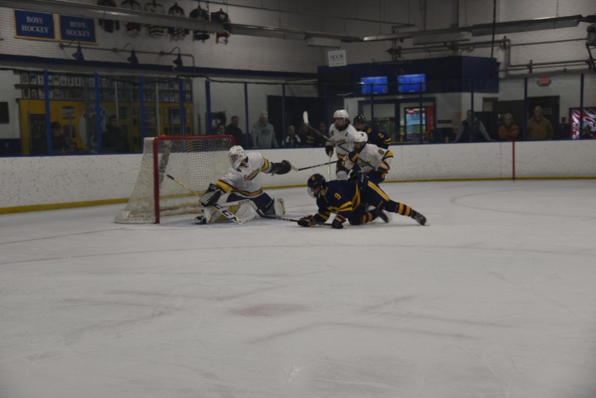 SAVE. Goalkeeper Brody Manning dives to save a shot. 