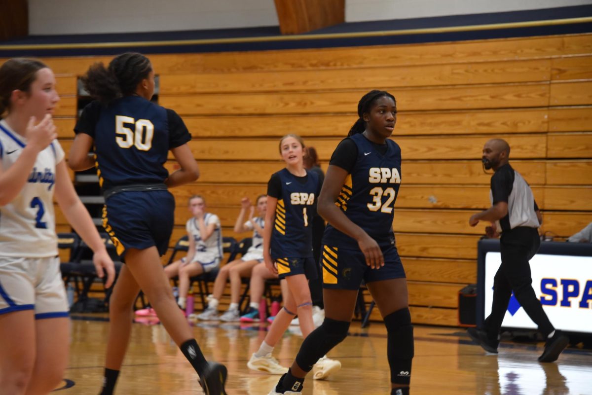 STAND OUT. Eighth-grader Amaya Obi-Walker walks to defend Trinity's offense. Obi-Walker played a key role in the Spartans' victory.