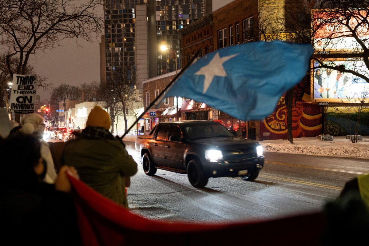 BAND TOGETHER. A demonstrator waves a flag of Somalia as a vehicle passes by a rally in protest against Immigration and Customs Enforcement (ICE), amid a reported federal immigration operation targeting the Somali community, in Minneapolis, Minnesota, U.S. December 8, 2025.  REUTERS/Tim Evans