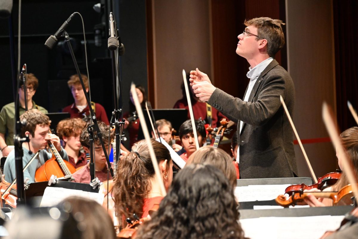 NEW CONDUCTOR. After former Jazz Band Director Randy Reid retires last year, Jack Breen fills his shoes. Breen assists in conducting the orchestra during rehearsals before the concert.