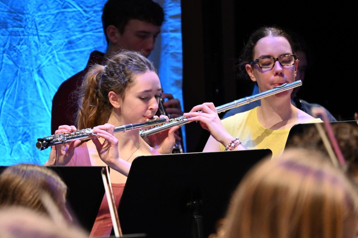 FLAUTISTS. Senior Franny Wagner and junior Chloe Kovarik play the flute for "Skyfall." 