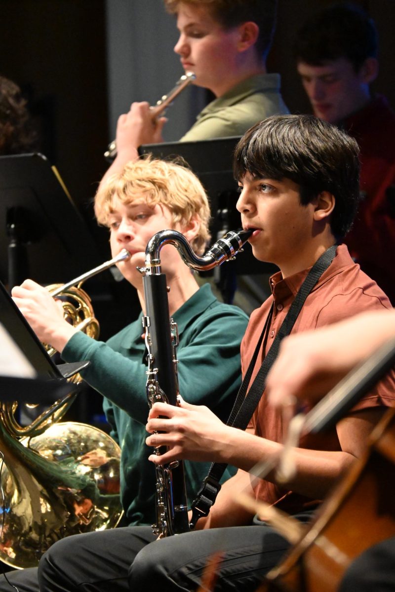 BRASS AND WOODWINDS. Ninth graders Arjun Kharbanda and Euan Levinson play the bass clarinet and French horn in Honors Sinfonia for "Skyfall" arranged by Larry Moore.