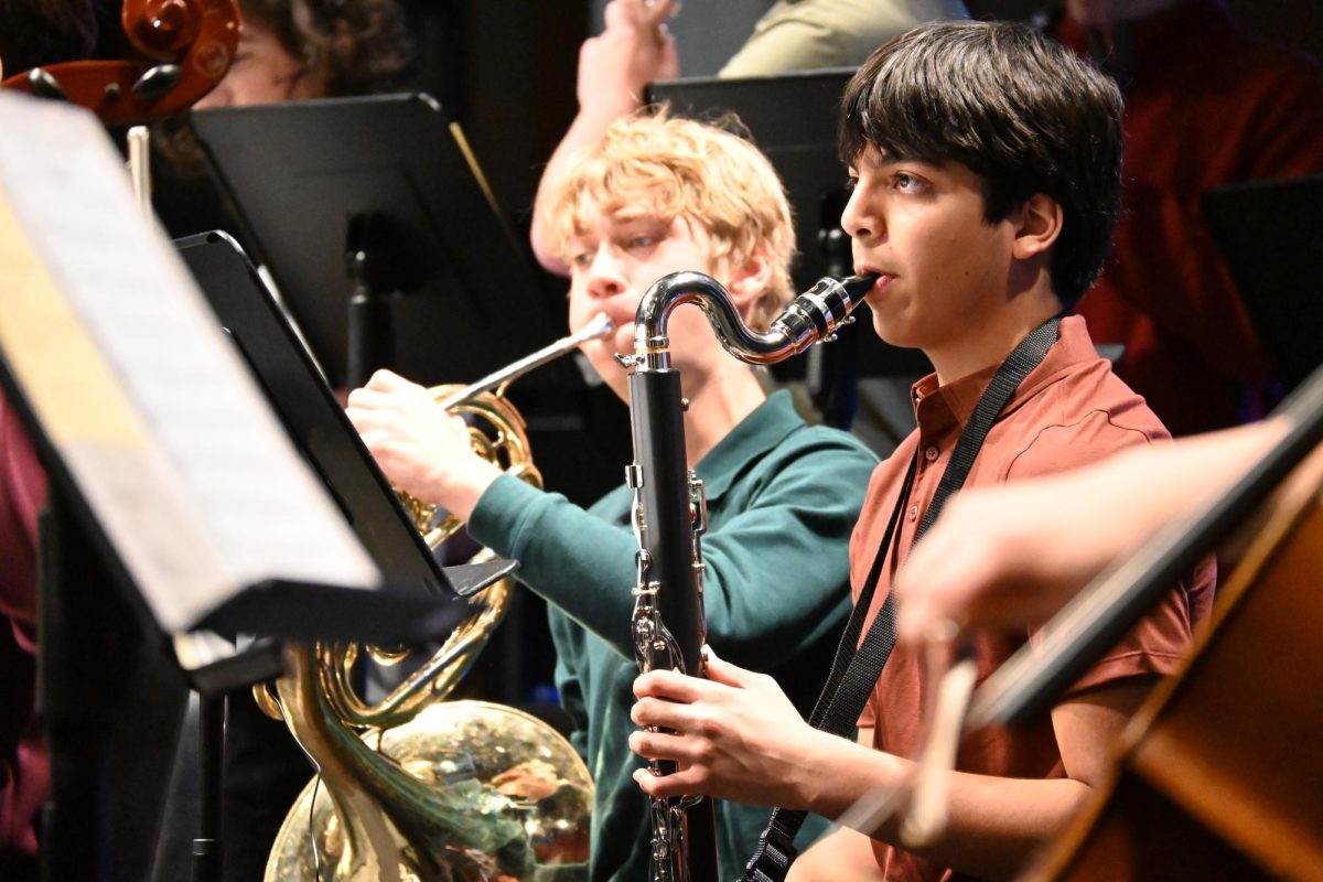 BRASS AND WOODWINDS. Ninth graders Arjun Kharbanda and Euan Levinson play the bass clarinet and French horn in Honors Sinfonia for "Skyfall" arranged by Larry Moore.