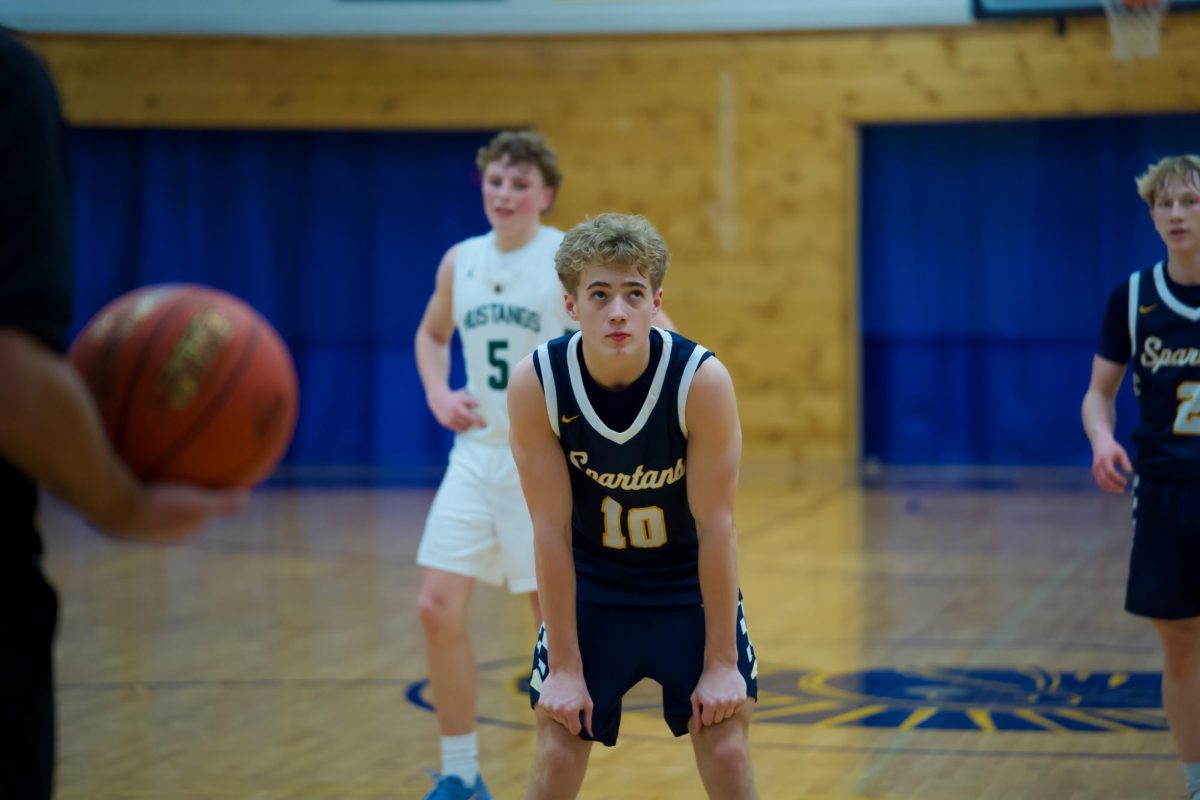 CHECKING SCORE. Sophomore Palmer Olson glances up at the score board before taking his second free throw.