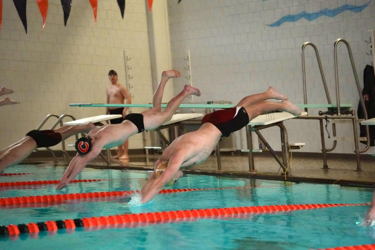 DIME DIVE. Finn Cox (SPA ‘25) starts his race with a powerful dive in a rivalry meat against St. Paul Central.