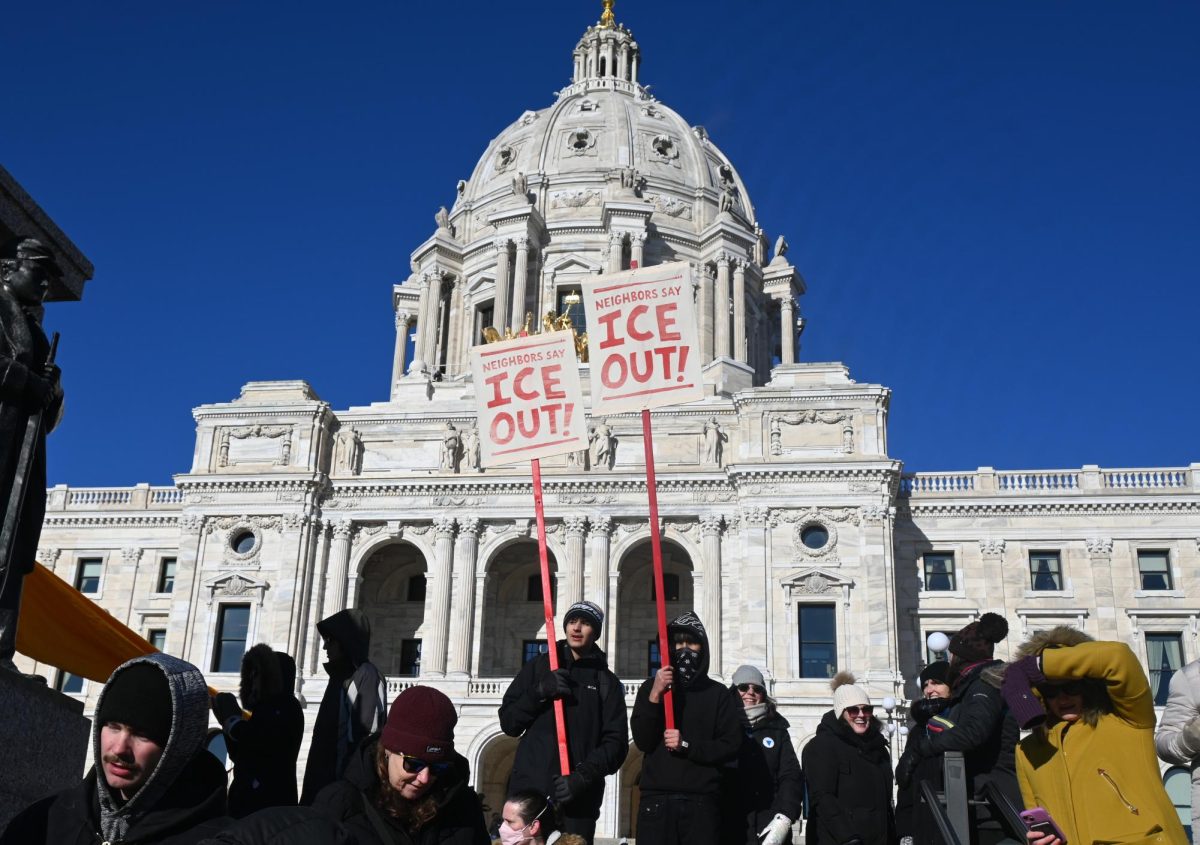 STAND UP. Many participants held painted signs with the message, "Neighbors say ICE out."