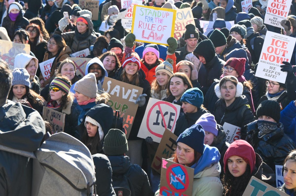 FRIGID FACES. SPA students hold their signs and huddle together during the protest.