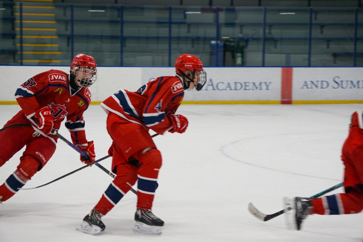 UNITED IN MOTION. Järfälla Hockey Club players warm up with laps around the rink alongside the Spartans.