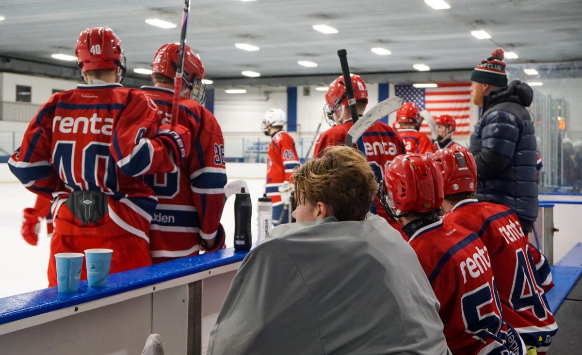 CROSSING BORDERS AND BENCHES. Järfälla Hockey Club players take a water break on the bench after running a few drills.