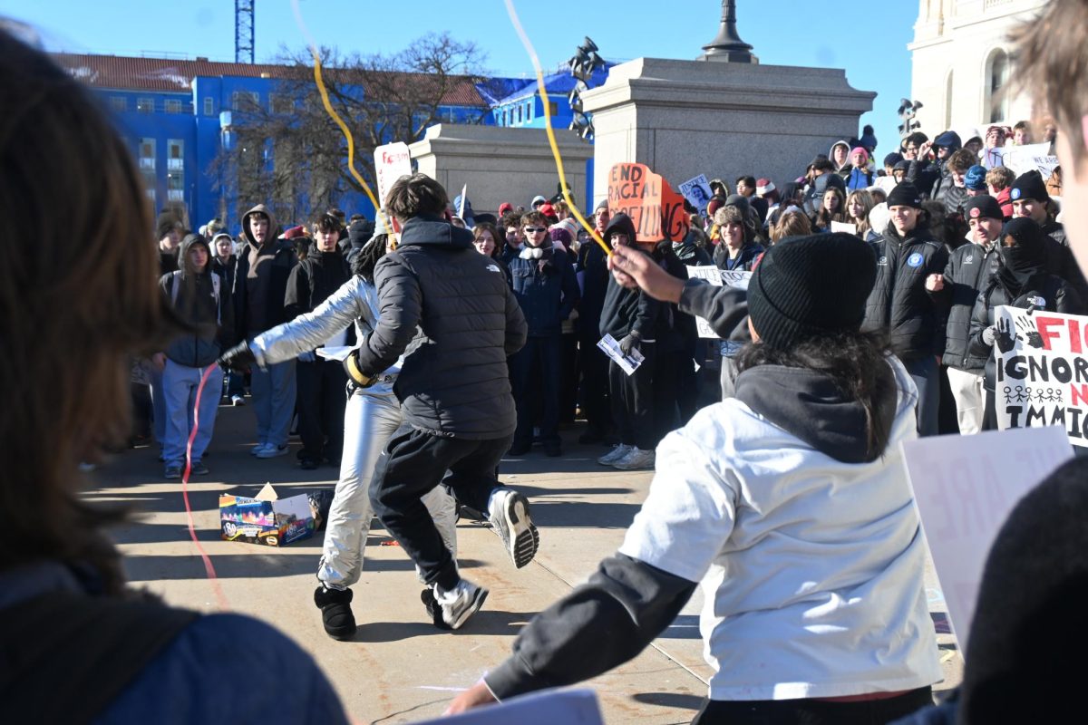 LIVELY LEAP. A student tries double-dutching in front of an energetic crowd of students. 