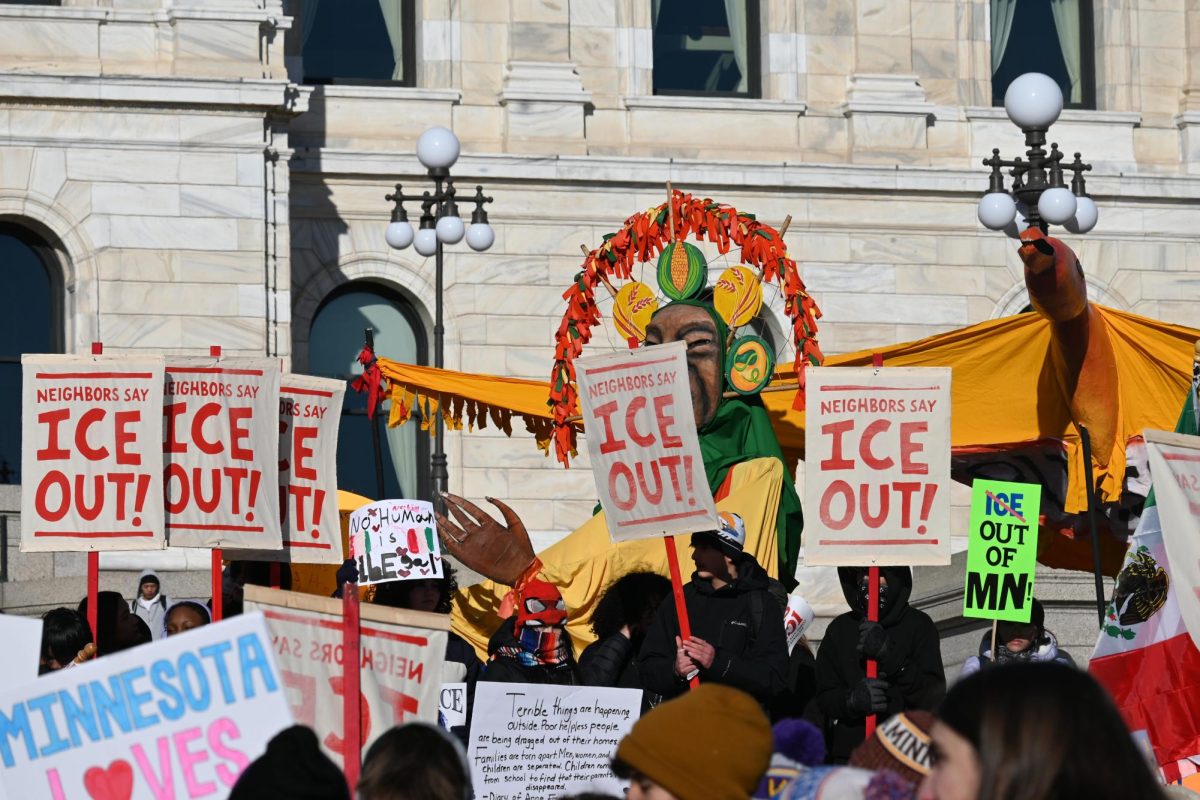 PROTEST. Demonstrators carry signs condemning Immigration and Customs Enforcement at a student walk-out and protest at the State Capitol on Jan. 16.