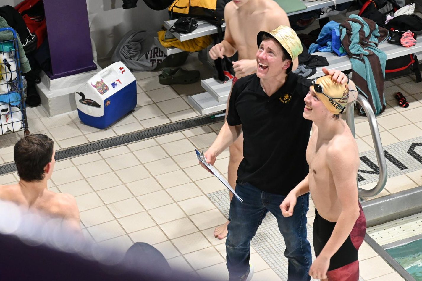 COACH SWAG. Coaches style their team spirit with bucket hats in the same metallic gold as swim caps.