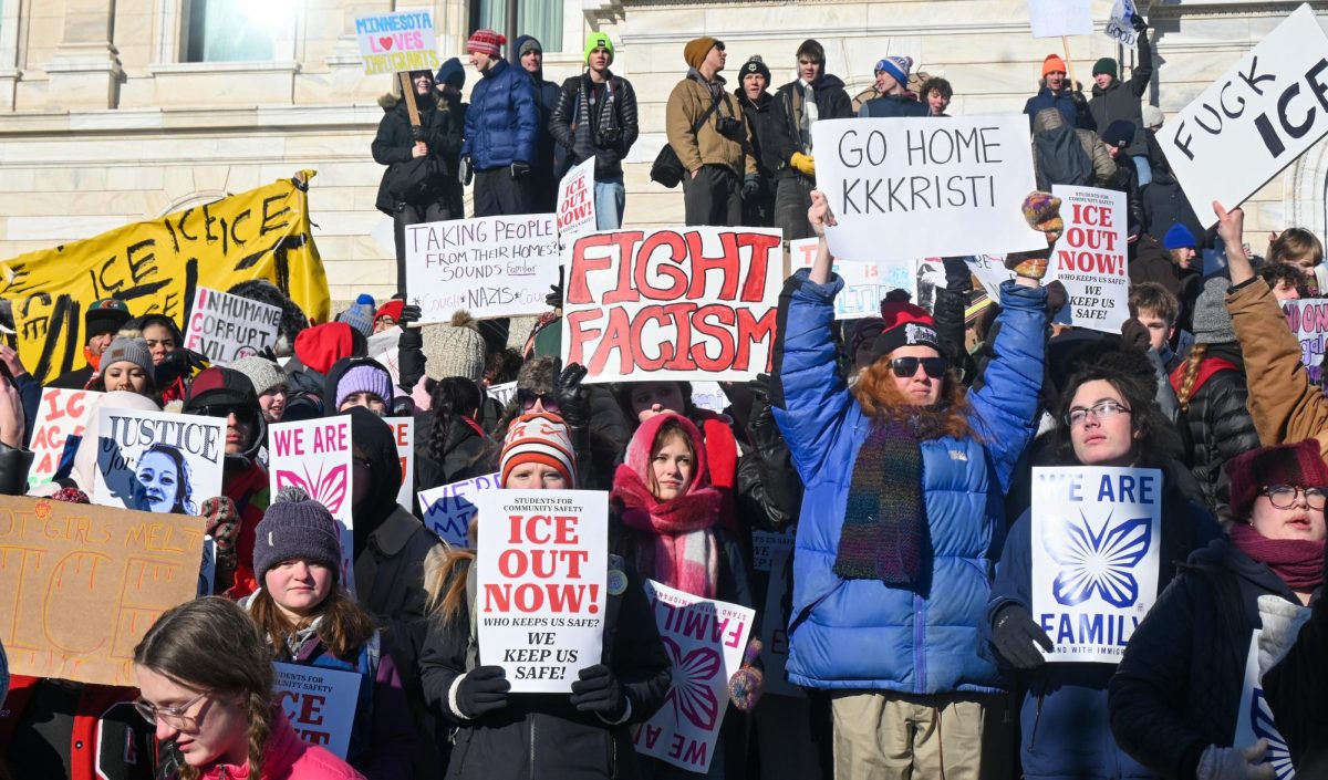 FIGHT FACISM. Holding protest signs, a group of students assemble on the top Capitol steps.