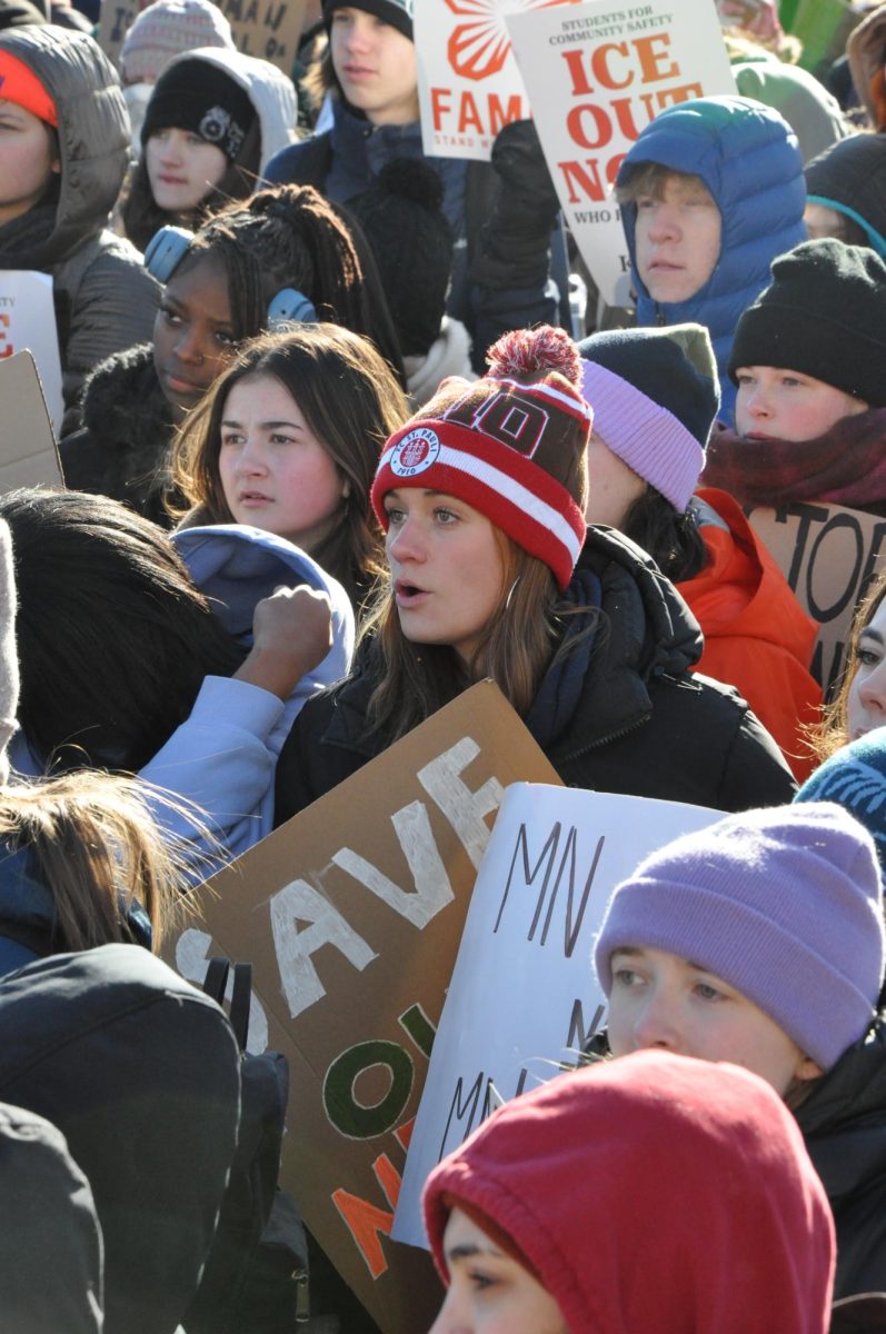 SUPPORT FROM WITHIN THE CROWD. Senior Laura Kimmel, alongside her friends, supports the student speakers. 