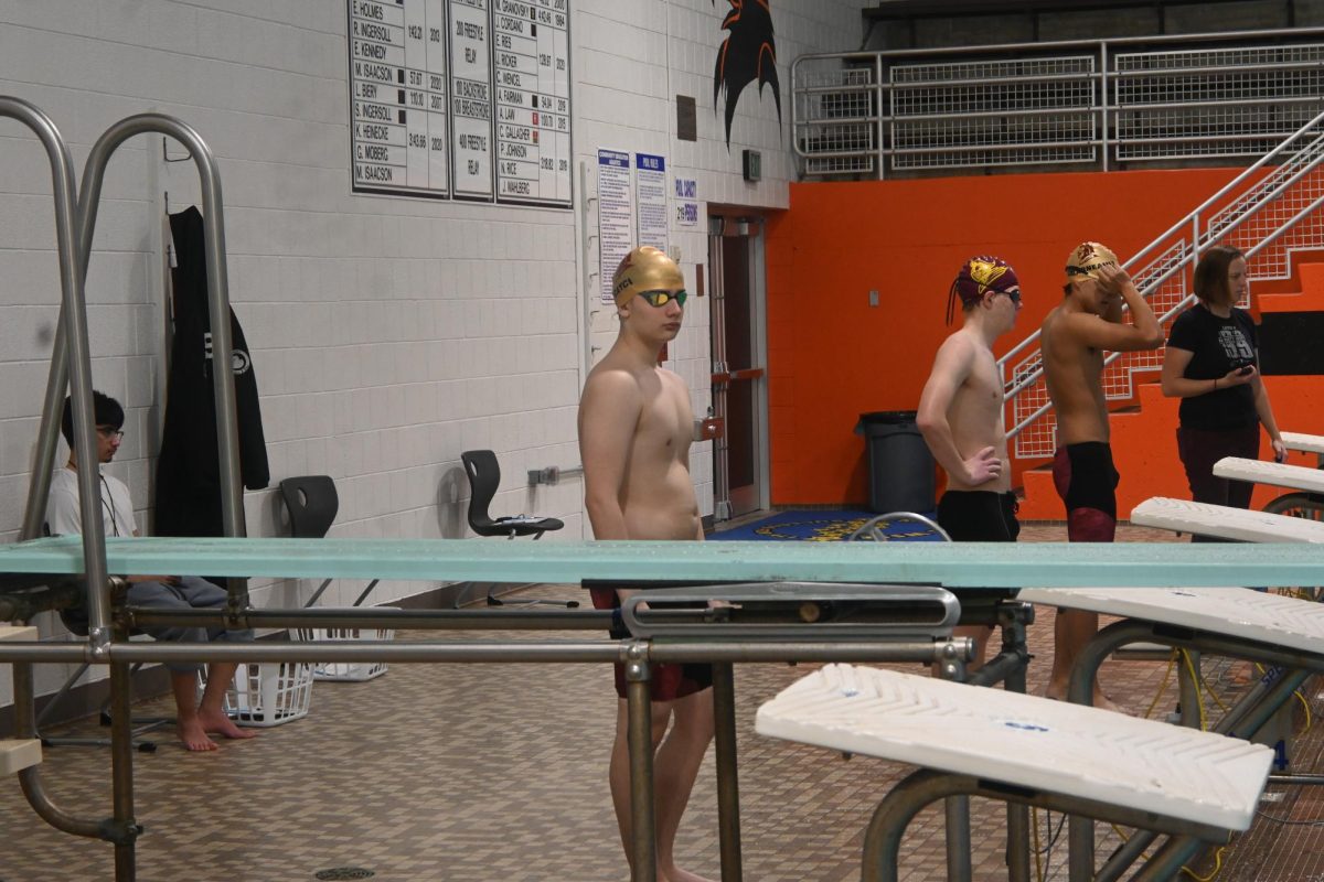 RACE TIME. Sophomore Kaya Cayci mentally prepares for the 100-yard butterfly race that starts in 2 minutes