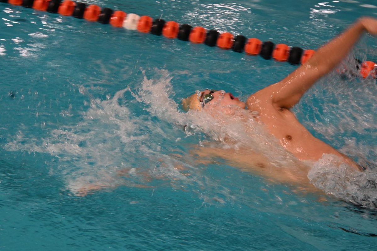 BACKSTROKE BLITZ. Captain Ben Lee dominates in the 100-yard backstroke event. Lee has been racing in this event since his freshman year.