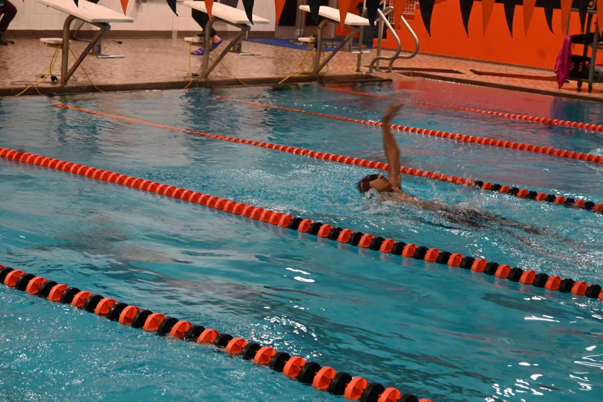 POWERING THROUGH. Junior Adi Narayan closes out the 100-yard backstroke.
