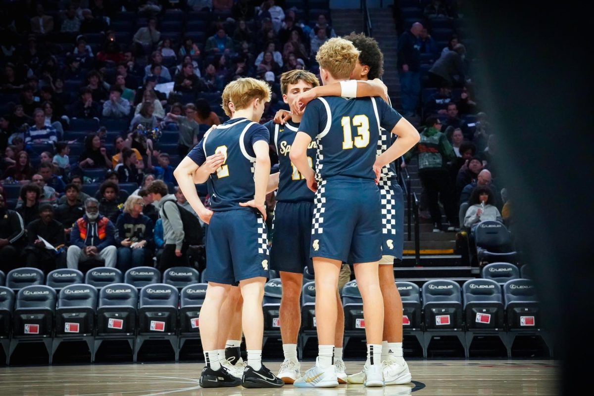 COME TOGETHER. Before the game started the Spartans met near half court to group up.