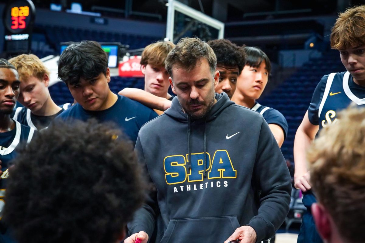 REGROUP. The Spartans regroup during halftime. With returning Coach Keto drawing out plays on the whiteboard.