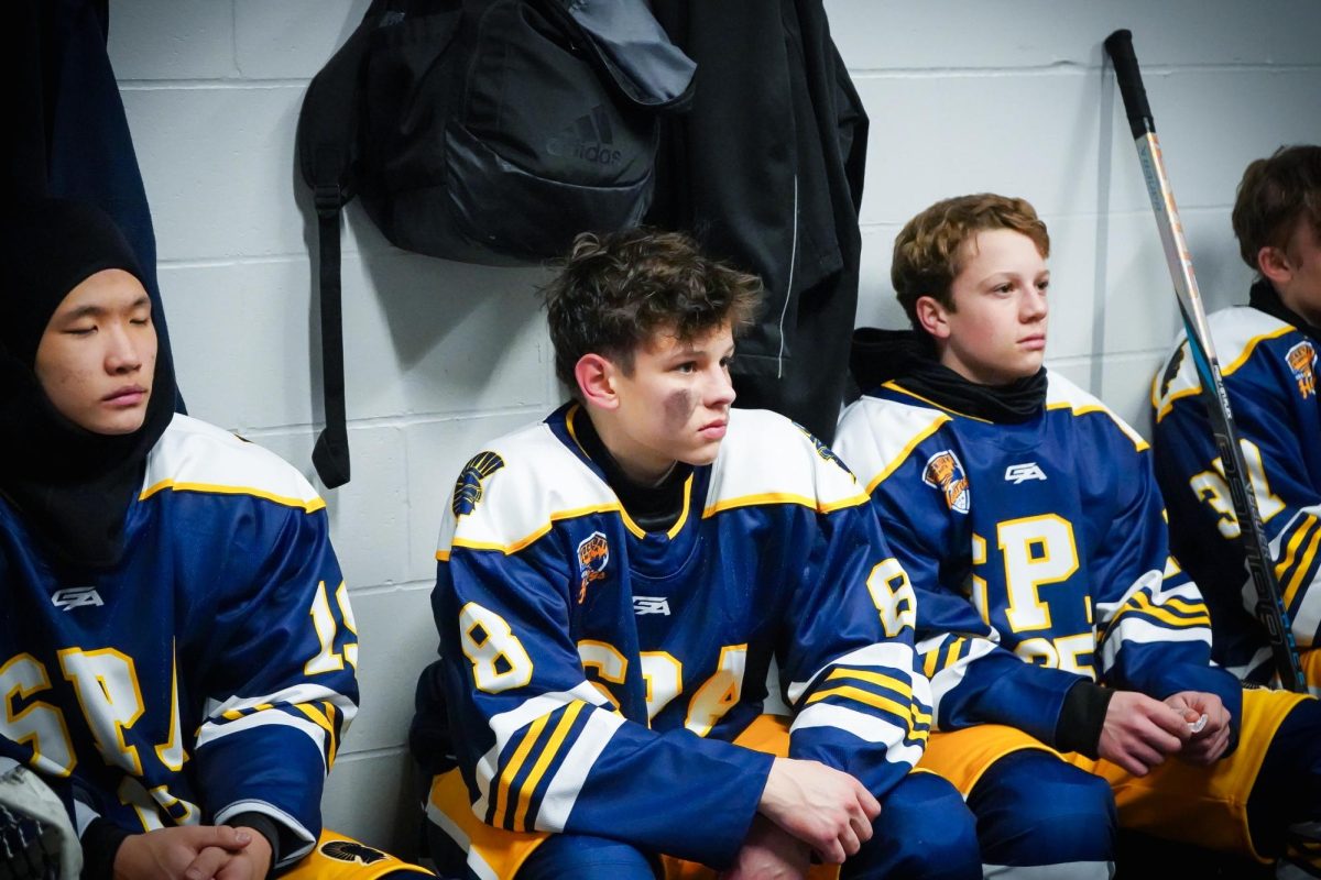 LOCKED. Sophomore Peter Berthiaume listens to the coaches talk in between periods. 