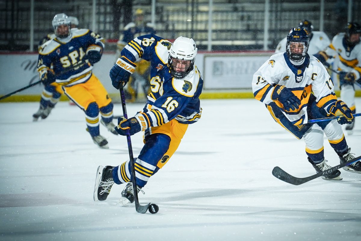DODGE. Junior Brady Glenn weaves through players.