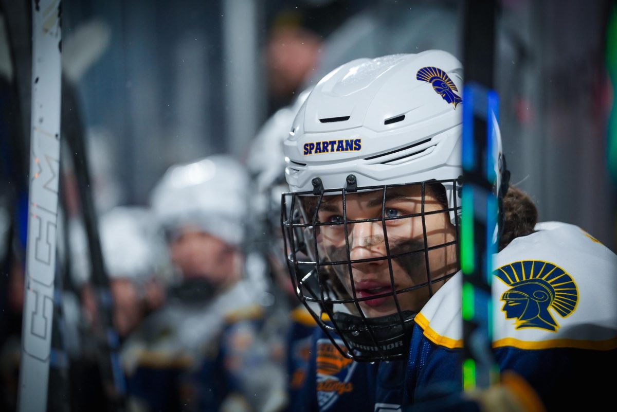 FOCUS.  Bennett Sauer stays alert by watching the game before his next shift.