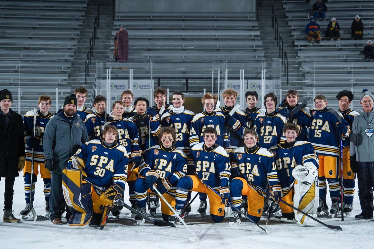 TEAM. The Spartans gathered on center ice for a group shot.
