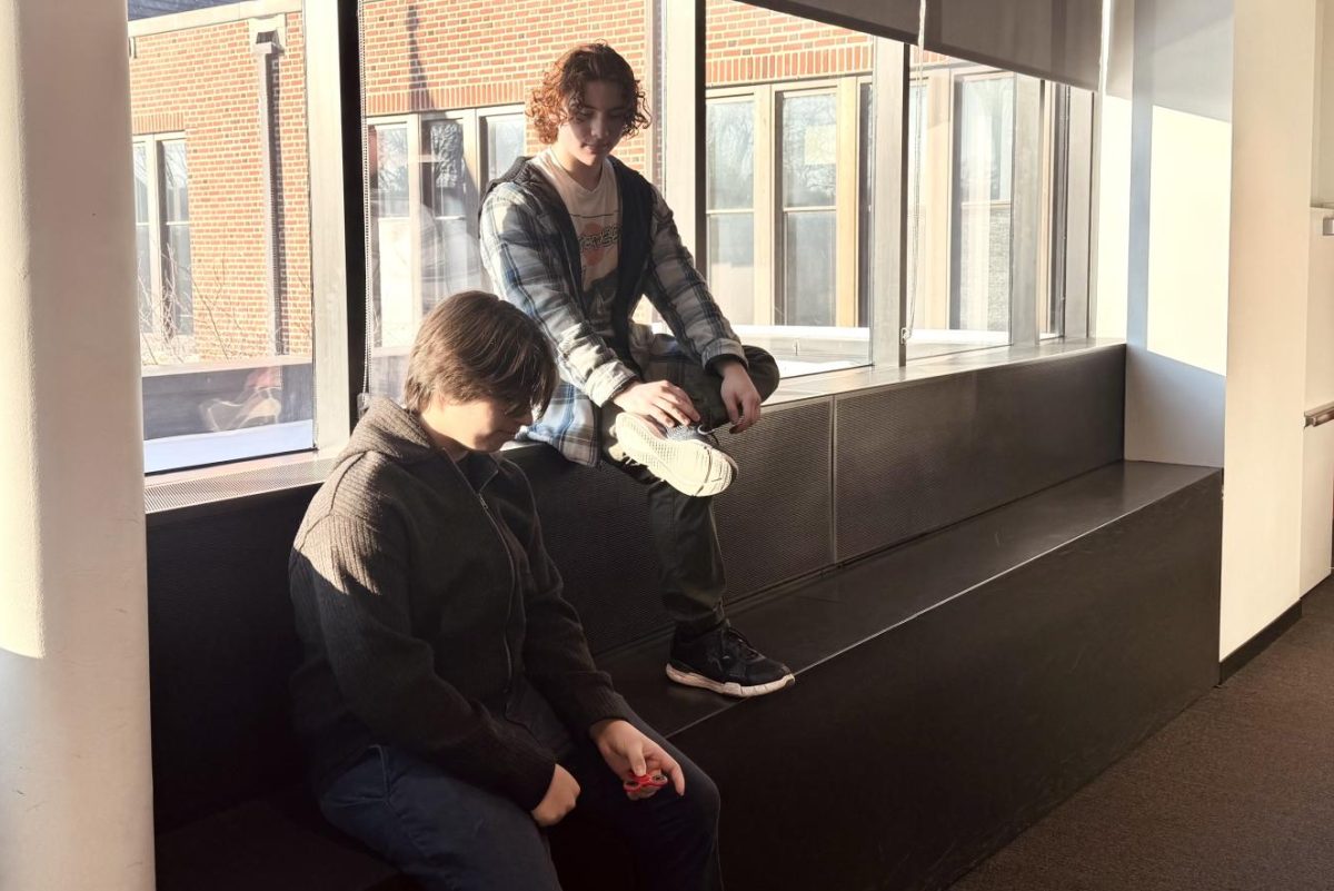 FILTER PHOTOS. Juniors Isaak Senaratna and Solomon Beardsley sit together while Senaratna plays with a fidget spinner. Also heavily edited with filters that were popular in the early 2010s. 