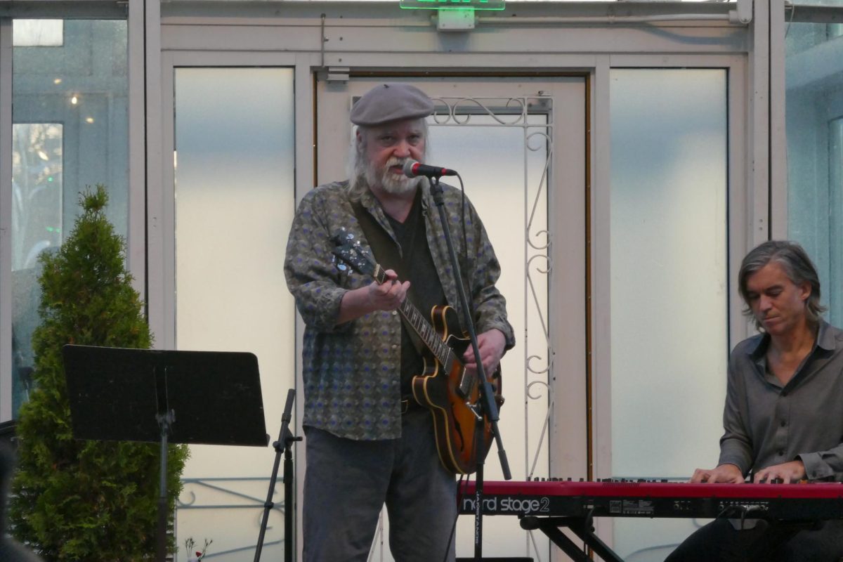 TWICE IS NICE. Guitarist Curt Obeda plays while he sings. 
