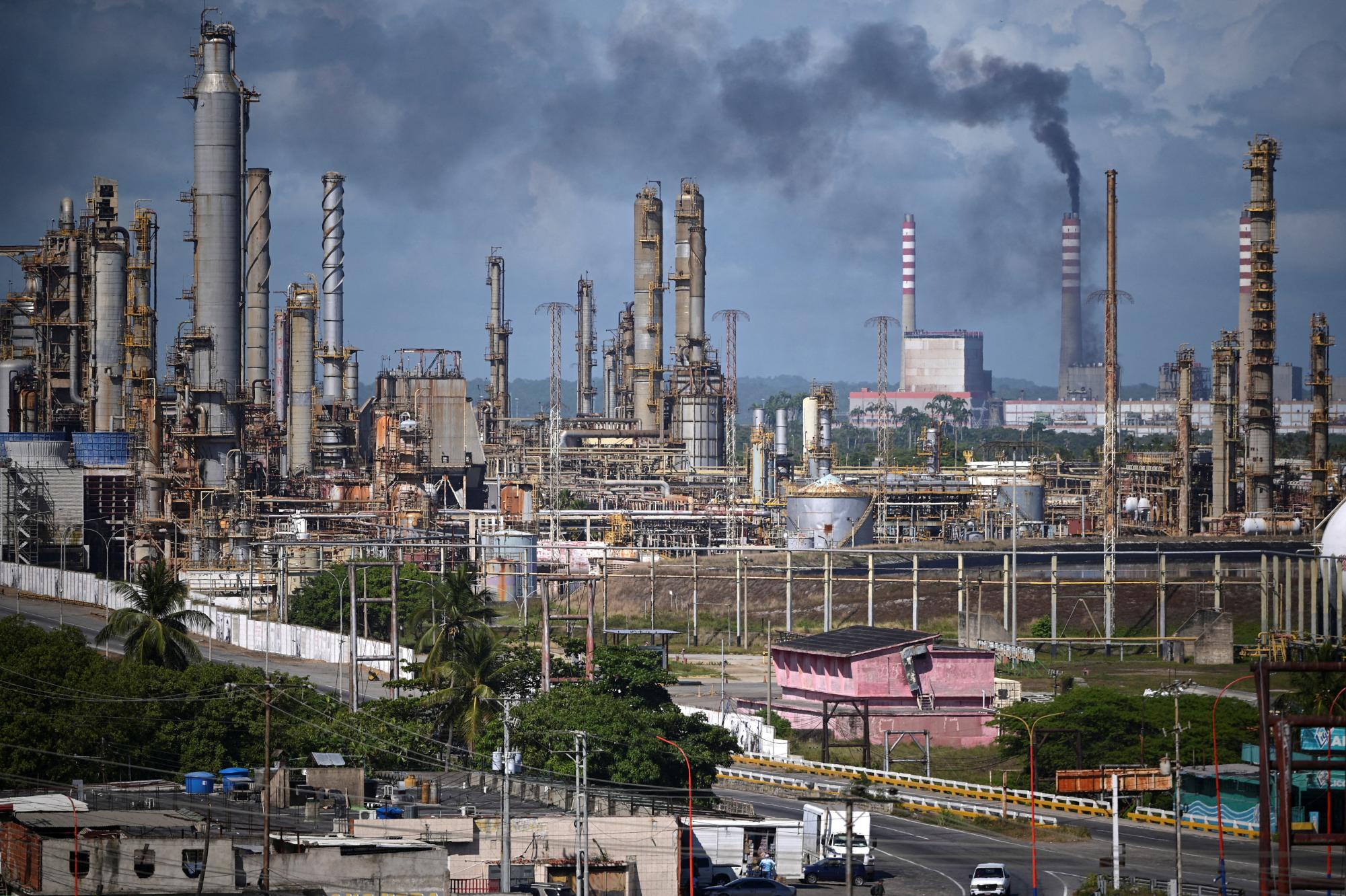 Installations at the El Palito refinery of Venezuelan state oil company PDVSA, with facilities of the national electricity company Corpoelec in the background, after the National Assembly approved a major reform of the country's main oil law, in Puerto Cabello, Venezuela, January 22, 2026. REUTERS/Gaby Oraa